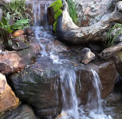 Watefall then stream and waterfall into pond.