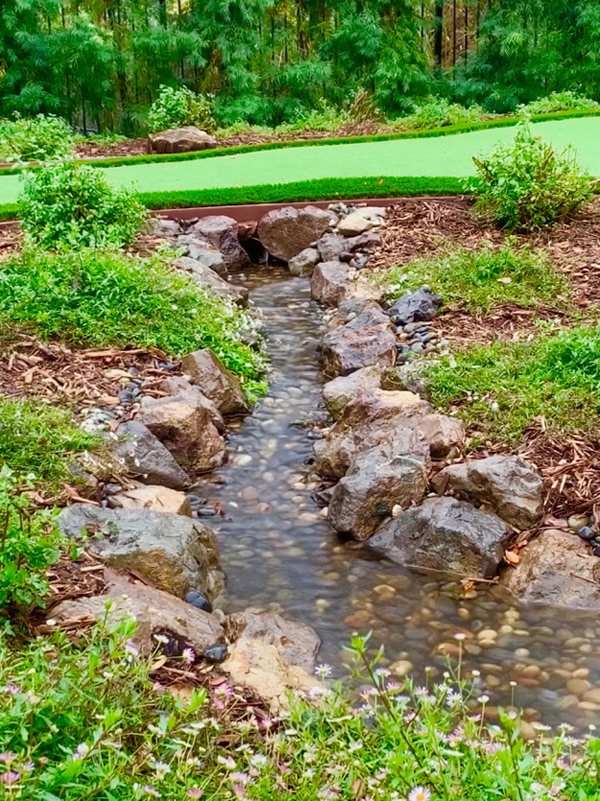 Putting Green passing over pondless waterfall-other view