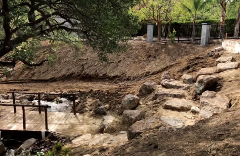 After the pondless waterfall was constructed, we designed a vineyard on the hillside to create a really magical environment.