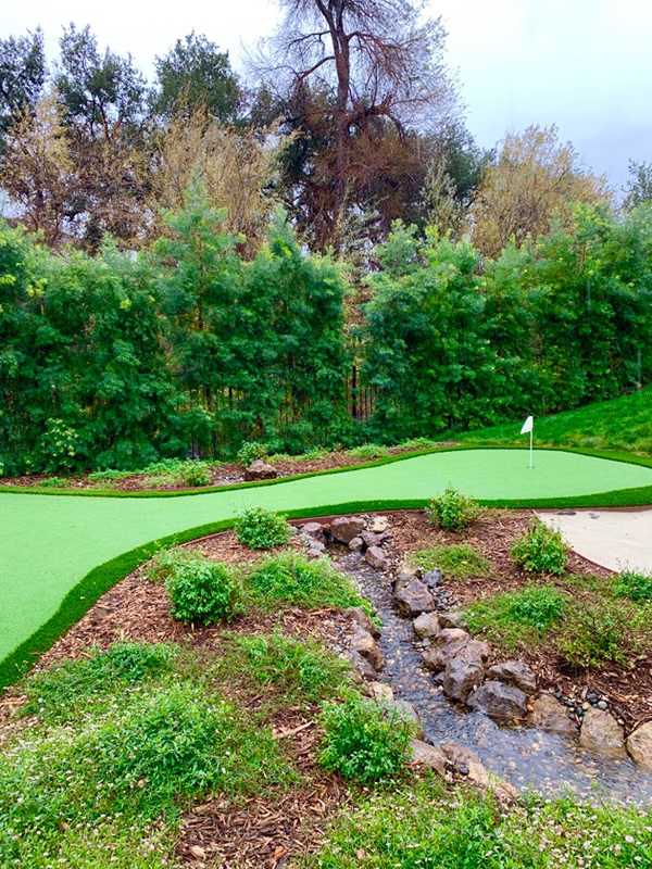 Putting Green passing over pondless waterfall