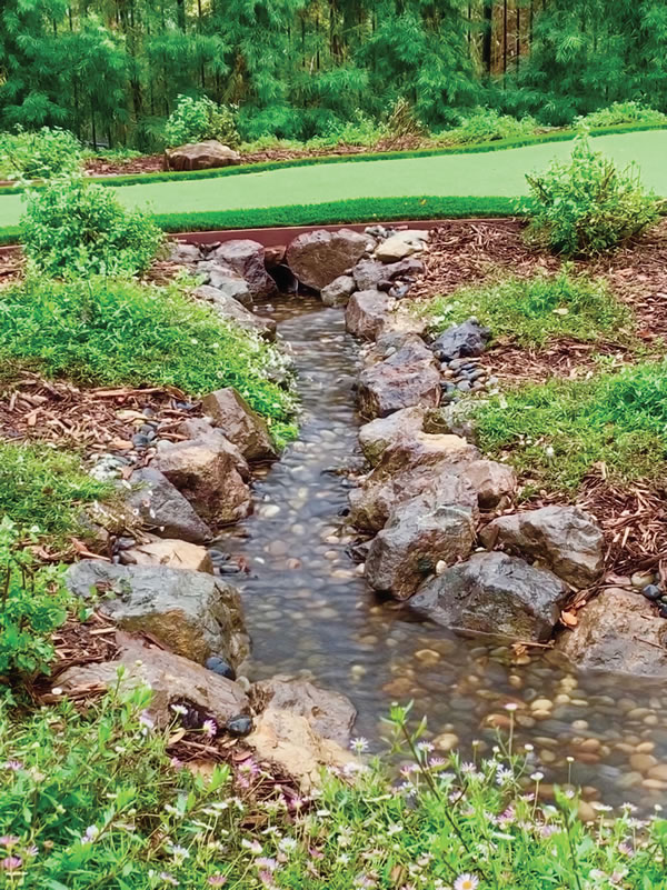 A water hazard (bottom) was created to enhance the experience of the putting green.