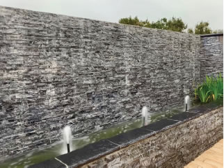 A large water wall was rebuilt to create a soothing environment in the client’s Zen meditation room.